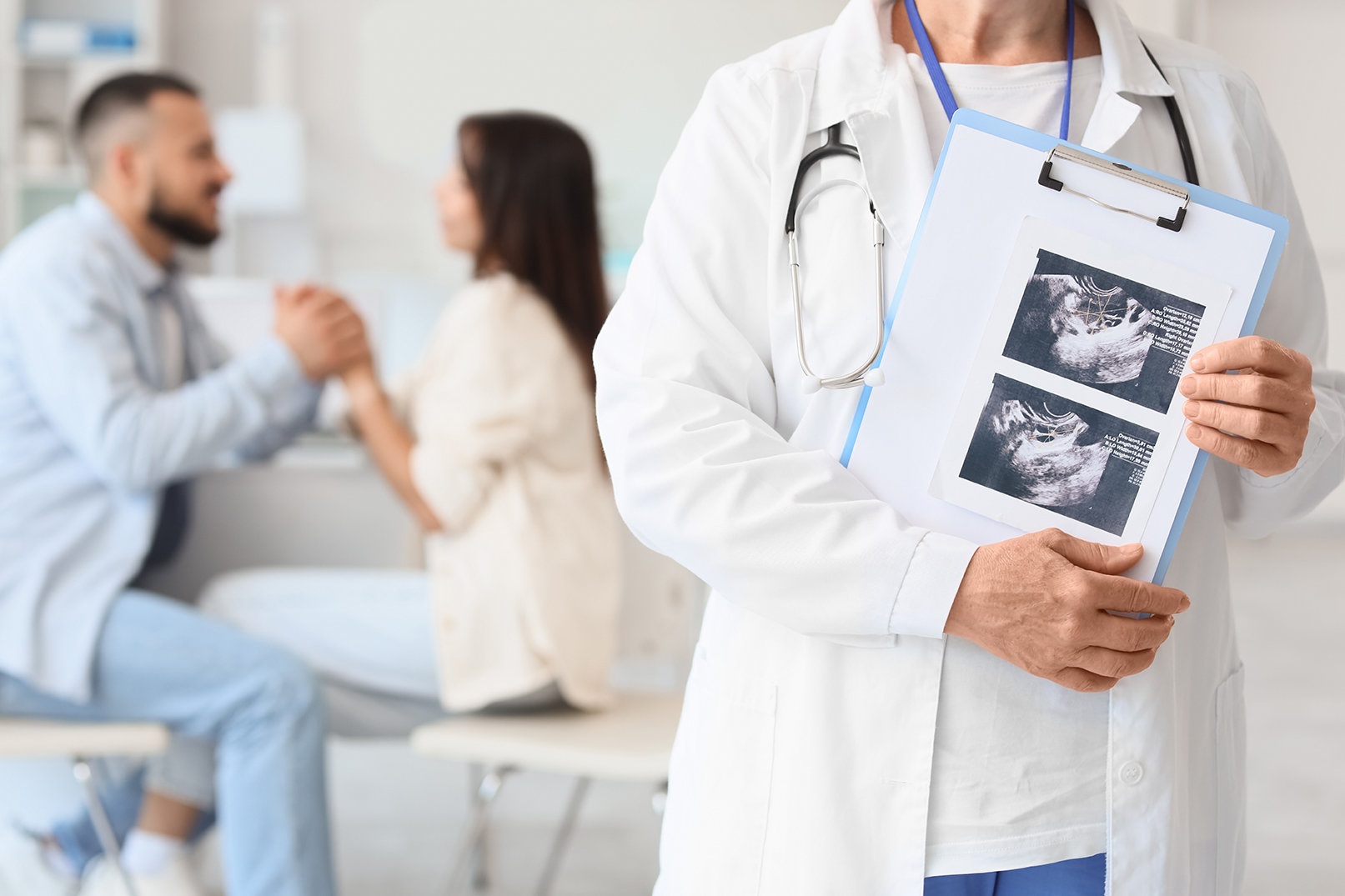 A couple in the background feeling excitement after a successful fertility journey
